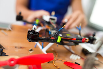 Image showing Man installing the component on drone body