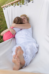 Image showing mother and a little daughter relaxing in a hammock