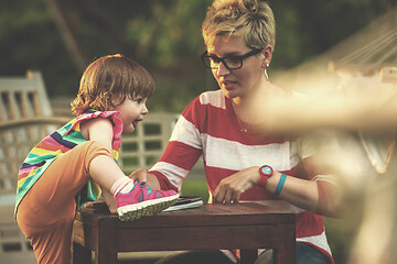 Image showing mom and her little daughter using tablet computer