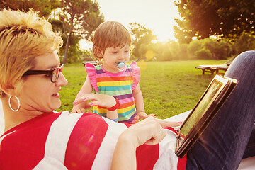 Image showing mom and a little daughter relaxing in a hammock