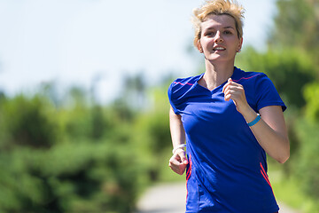 Image showing young female runner training for marathon