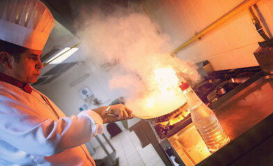 Image showing Chef doing flambe on food