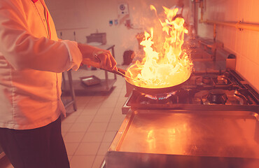 Image showing Chef doing flambe on food