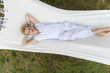 Image showing young woman resting on hammock