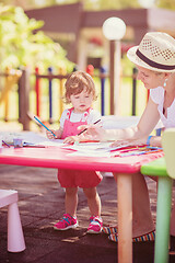 Image showing mom and little daughter drawing a colorful pictures