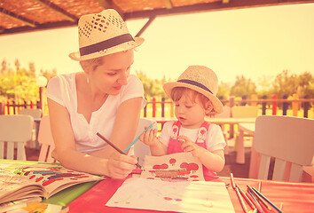 Image showing mom and little daughter drawing a colorful pictures