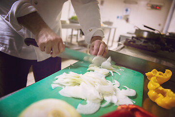 Image showing Chef hands cutting fresh and delicious vegetables