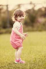 Image showing little girl spending time at backyard