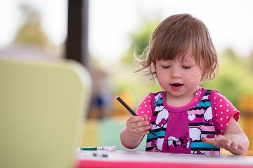 Image showing little girl drawing a colorful pictures