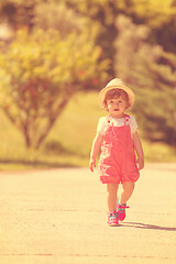 Image showing little girl runing in the summer Park