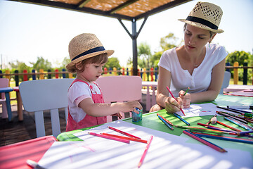 Image showing mom and little daughter drawing a colorful pictures