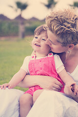 Image showing mother and little daughter playing at backyard