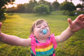 Image showing little girl spending time at backyard