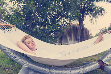 Image showing young woman resting on hammock