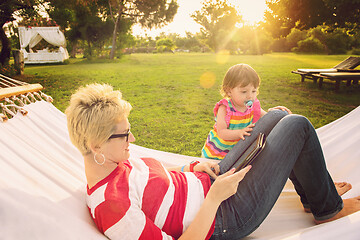 Image showing mom and a little daughter relaxing in a hammock