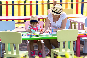 Image showing mom and little daughter drawing a colorful pictures