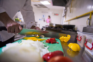 Image showing Chef hands cutting fresh and delicious vegetables