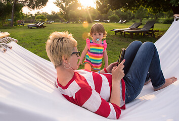 Image showing mom and a little daughter relaxing in a hammock