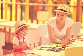 Image showing mom and little daughter drawing a colorful pictures