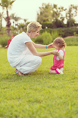 Image showing mother and little daughter playing at backyard