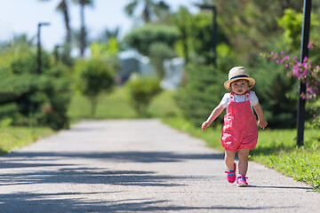 Image showing little girl runing in the summer Park