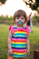 Image showing little girl spending time at backyard