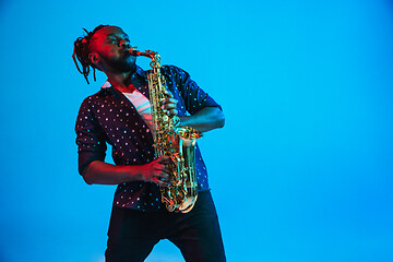 Image showing Young african-american jazz musician playing the saxophone