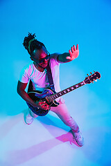 Image showing Young african-american jazz musician playing the guitar