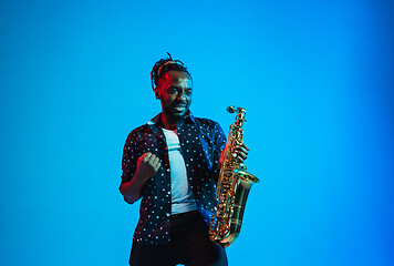 Image showing Young african-american jazz musician playing the saxophone