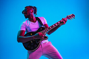 Image showing Young african-american jazz musician playing the guitar