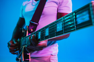 Image showing Young african-american jazz musician playing the guitar