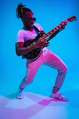 Image showing Young african-american jazz musician playing the guitar