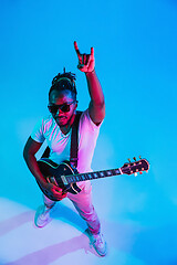 Image showing Young african-american jazz musician playing the guitar