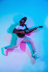 Image showing Young african-american jazz musician playing the guitar