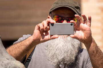 Image showing man with a beard taking a photograph with his smart phone