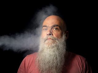 Image showing bearded man gets smoke in his face portrait