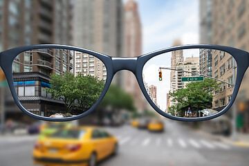 Image showing glasses with sharp and blurred big city