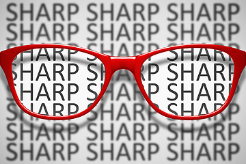 Image showing red glasses with text sharp and blurred