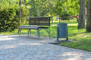 Image showing A shop in the park, there is a street trash can next to it