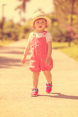 Image showing little girl runing in the summer Park