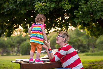 Image showing mom and her little daughter using tablet computer