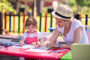 Image showing mom and little daughter drawing a colorful pictures