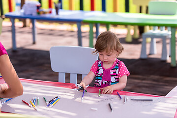 Image showing little girl drawing a colorful pictures