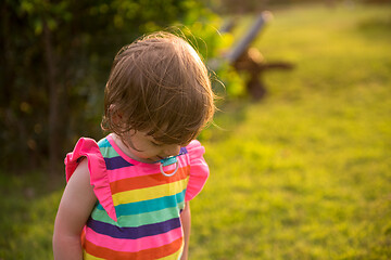 Image showing little girl spending time at backyard