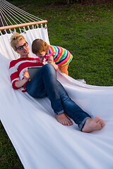 Image showing mom and a little daughter relaxing in a hammock