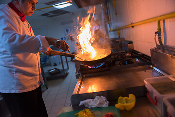 Image showing Chef doing flambe on food