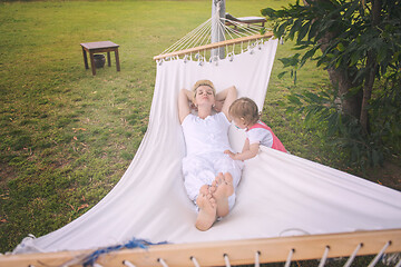 Image showing mother and a little daughter relaxing in a hammock