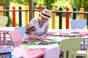 Image showing mom and little daughter drawing a colorful pictures