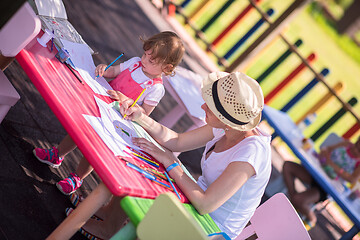 Image showing mom and little daughter drawing a colorful pictures