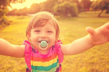 Image showing little girl spending time at backyard